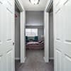a view of a bedroom from a hallway with white doors at Carisbrooke at Manchester Apartments, New Hampshire, 03102