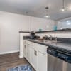 a kitchen with white cabinets and a sink and a stove at Carisbrooke at Manchester Apartments, New Hampshire, 03102