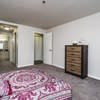 a living room with a pink rug and a dresser at Carisbrooke at Manchester Apartments, Manchester, New Hampshire
