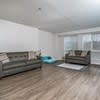 a living room with two couches and a window at Carisbrooke at Manchester Apartments, Manchester