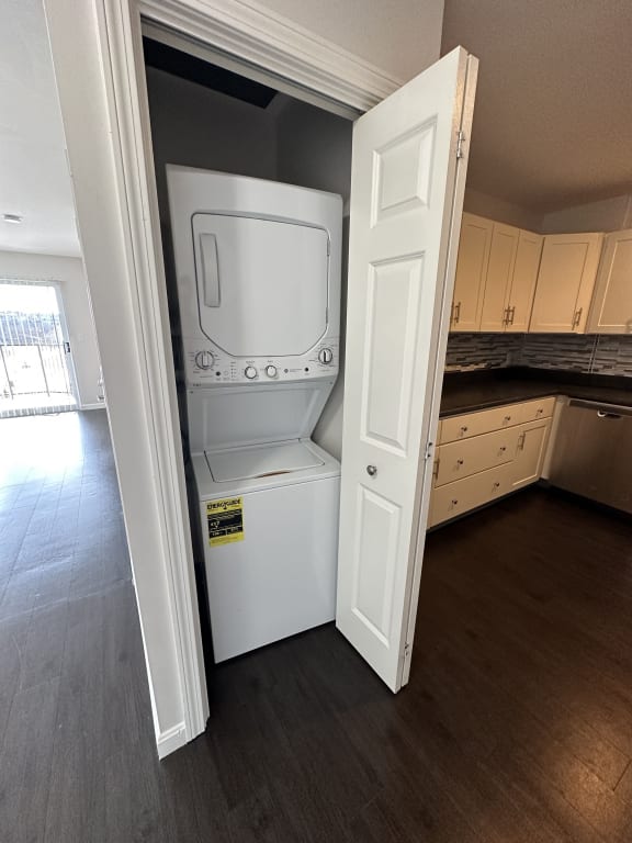 an empty kitchen with a washer and dryer in the door at Carisbrooke at Manchester Apartments, Manchester, NH