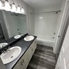 a black and white photo of a bathroom with two sinks at Carisbrooke at Manchester Apartments, Manchester, 03102