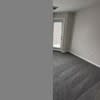 an empty living room in a house with a window at Carisbrooke at Manchester Apartments, New Hampshire, 03102