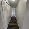 a long hallway with a door and stairs at Carisbrooke at Manchester Apartments, Manchester