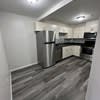 a blurry picture of a kitchen with a refrigerator at Carisbrooke at Manchester Apartments, New Hampshire, 03102