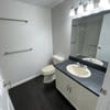 a white bathroom with a sink and a toilet at Carisbrooke at Manchester Apartments, Manchester, 03102