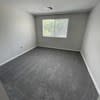 an empty room in a house with a window at Carisbrooke at Manchester Apartments, Manchester, NH