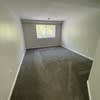 a empty room with a window and a wooden floor at Carisbrooke at Manchester Apartments, New Hampshire