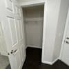 a hallway with a closet and a white door at Carisbrooke at Manchester Apartments, New Hampshire, 03102