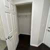 a hallway with a closet and a white door at Carisbrooke at Manchester Apartments, Manchester