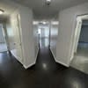 the hallway of a building with white walls and doors at Carisbrooke at Manchester Apartments, Manchester, New Hampshire