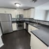 a kitchen with a stove and a refrigerator at Carisbrooke at Manchester Apartments, New Hampshire