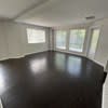 a empty room with a wood floor and windows at Carisbrooke at Manchester Apartments, Manchester, 03102