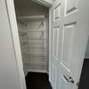 a hallway with a closet and a white door at Carisbrooke at Manchester Apartments, New Hampshire, 03102