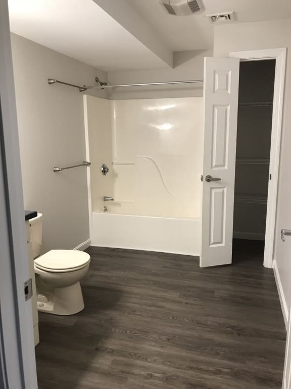 a small bathroom with a toilet and a shower at Carisbrooke at Manchester Apartments, New Hampshire