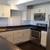 a kitchen with a stove a sink and a microwave at Carisbrooke at Manchester Apartments, New Hampshire