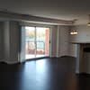 an empty living room with a door to a balcony at Carisbrooke at Manchester Apartments, Manchester, 03102