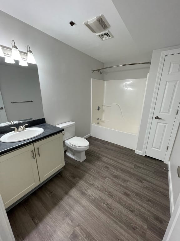 an empty bathroom with a toilet and a sink at Carisbrooke at Manchester Apartments, Manchester, 03102