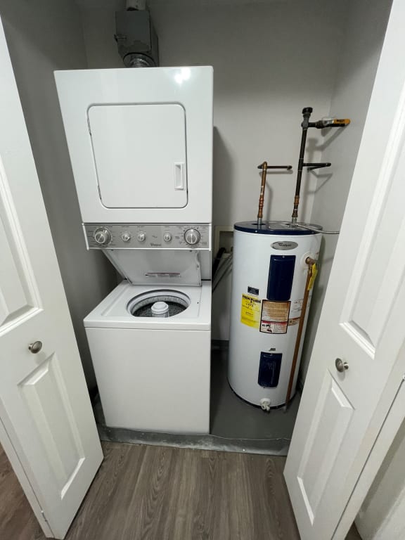 a small laundry room with a washing machine and a dryer at Carisbrooke at Manchester Apartments, Manchester, NH