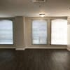 an empty living room with three windows at Carisbrooke at Manchester Apartments, Manchester