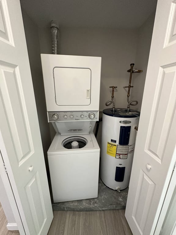 a small bathroom with a toilet and a washing machine at Carisbrooke at Manchester Apartments, Manchester
