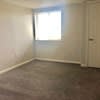 an empty room with a window and a door at Carisbrooke at Manchester Apartments, Manchester, New Hampshire