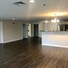 an empty living room with a hard wood floor at Carisbrooke at Manchester Apartments, Manchester