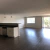an empty living room with a kitchen in it at Carisbrooke at Manchester Apartments, New Hampshire