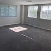 an empty living room in a house with windows at Carisbrooke at Manchester Apartments, Manchester, New Hampshire