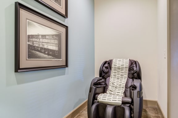 a massage chair in a room with a picture on the wall