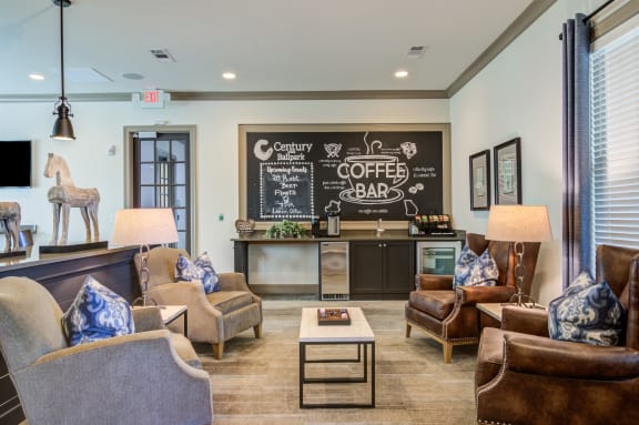 a living room with couches and chairs and a bar with a chalkboard