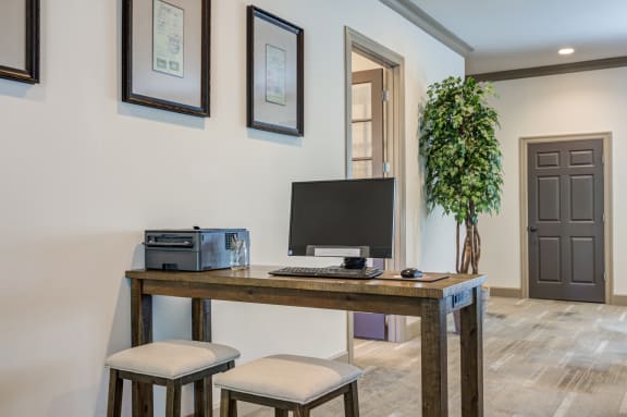 a home office with a computer and a printer on a desk