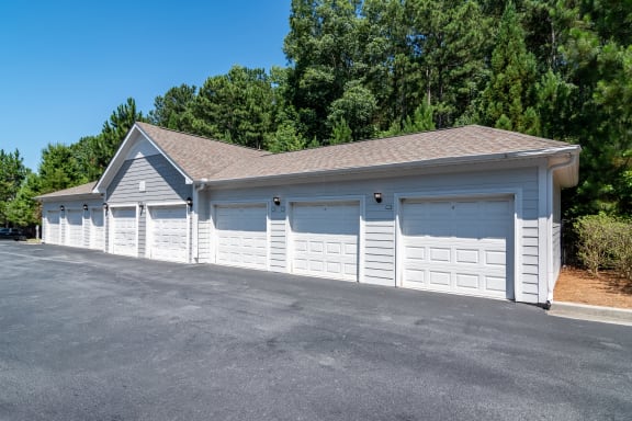 a white garage with white doors and a parking lot