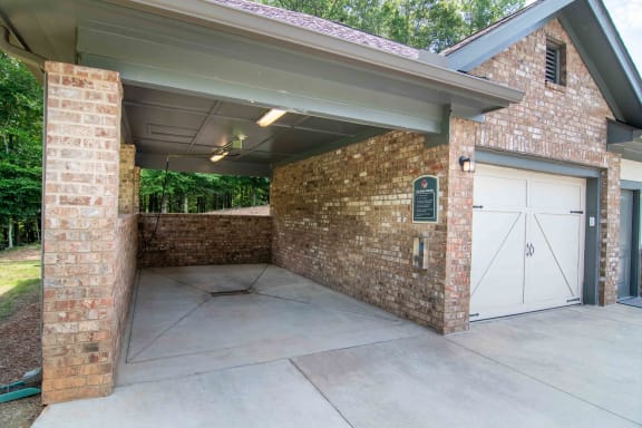 the garage of a house with white doors and a cement driveway at Century New Holland, Georgia