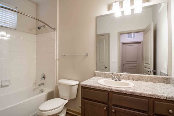 a bathroom with a sink and a toilet and a tub at Century New Holland, Georgia, 30501