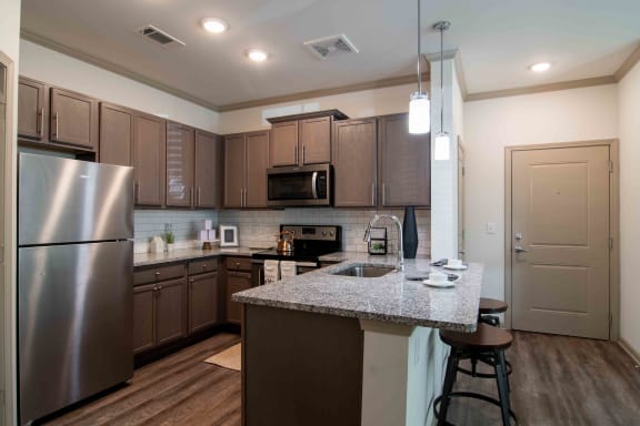a large kitchen with stainless steel appliances and granite counter tops  at Century New Holland, Georgia