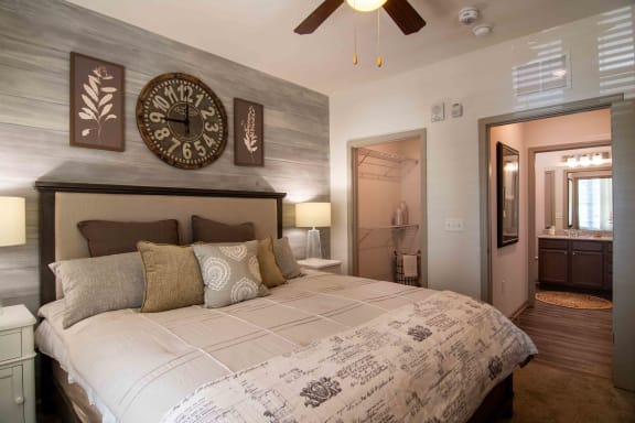 a bedroom with a large bed and a clock on the wall  at Century New Holland, Gainesville