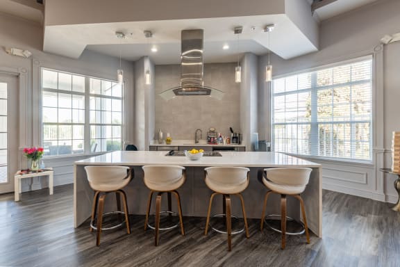 a kitchen with a large island with four stools