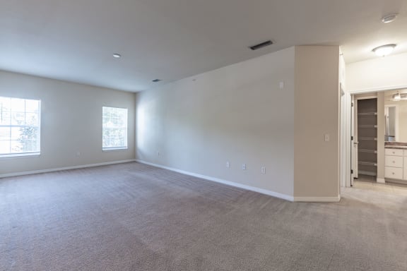 the living room of an empty house with white walls
