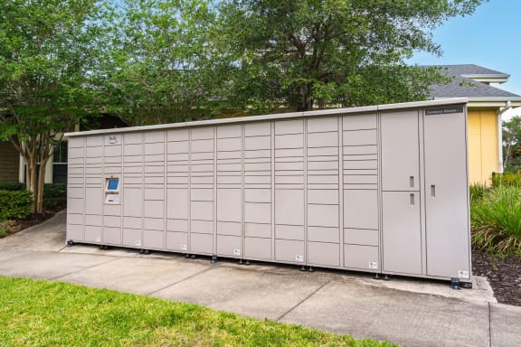 a small garage with a door on the side of a driveway