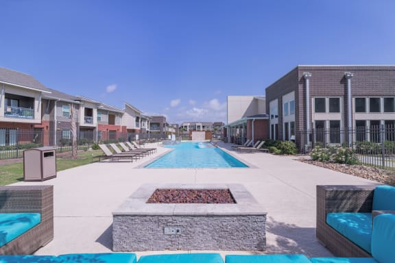 a swimming pool with a fire pit in front of an apartment building at Century Palm Bluff, Portland