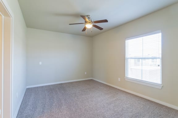 an empty room with a ceiling fan and a window at Century Palm Bluff, Portland, TX, 78374