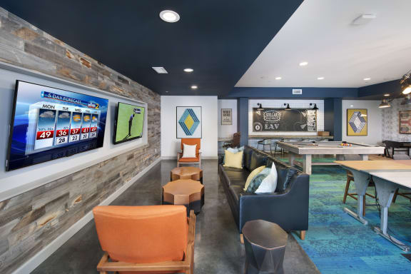 a recreation room with a shuffleboard table and couches at Marley EAV, Atlanta, Georgia