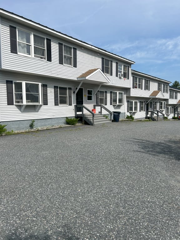 a row of white houses on a gravel road a row of white houses on a gravel road at Briarcliff at Quechee Apartments, Vermont