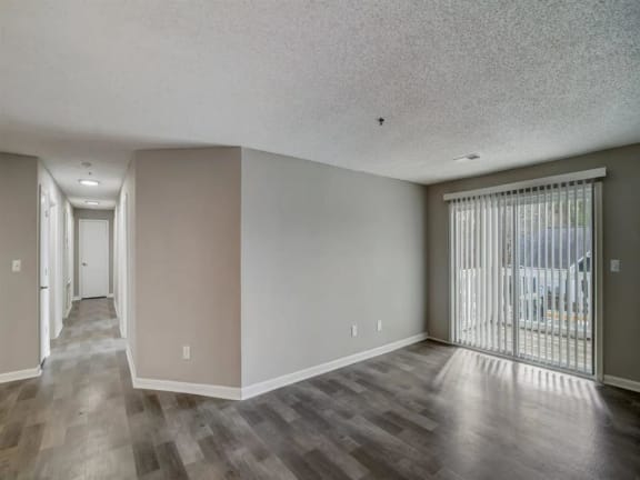 a living room with a sliding glass door to a balcony
