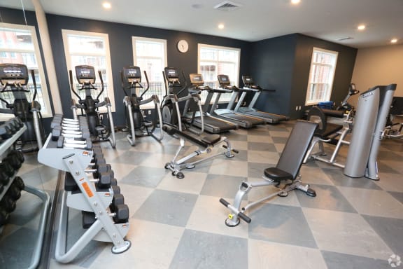 a gym with cardio equipment and weights on a checkered floor at Century Baxter Avenue, Louisville, 40204