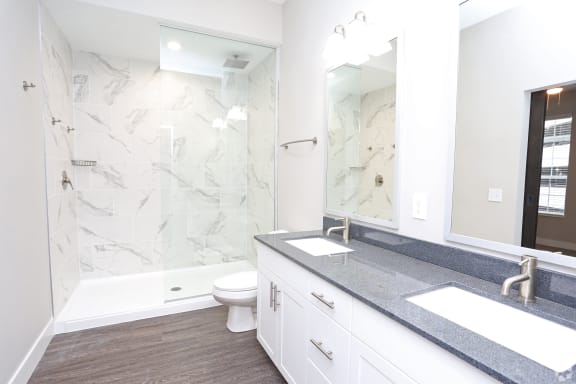 a bathroom with a shower and a sink and a mirror at Century Baxter Avenue, Kentucky, 40204