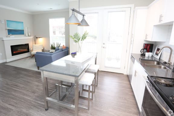 a view of a kitchen and living room with a table and chairs at Century Baxter Avenue, Kentucky, 40204