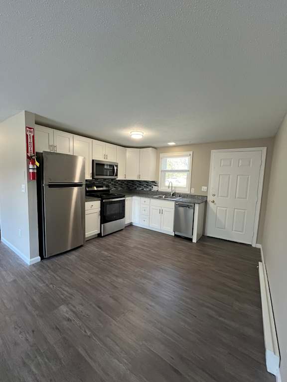 A kitchen with a refrigerator, stove, and oven.