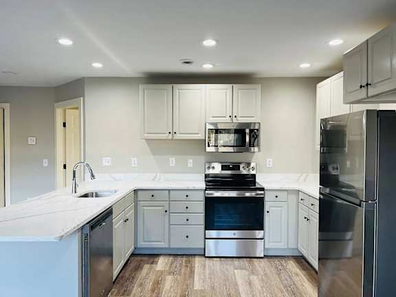 A modern kitchen with stainless steel appliances and wooden floors. at Briarcliff at Quechee, Vermont